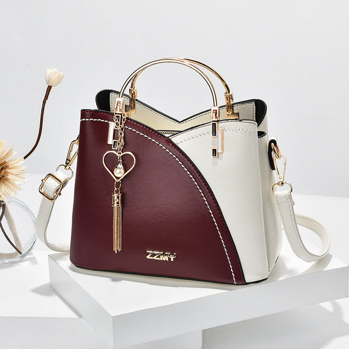 Color block handbag with heart tassel