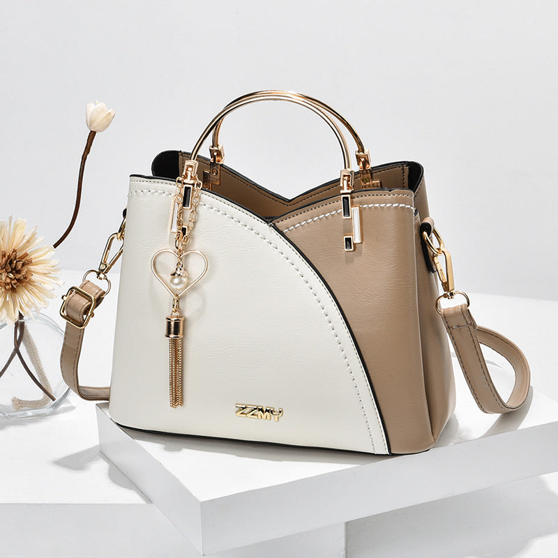 Color block handbag with heart tassel