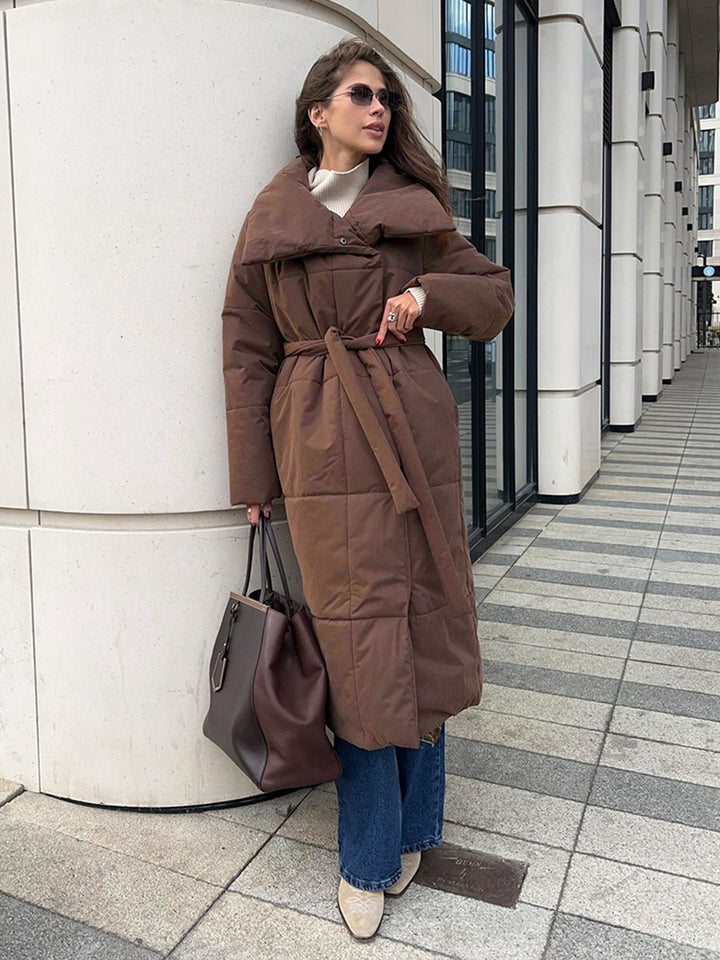 Woman in a long quilted belted coat