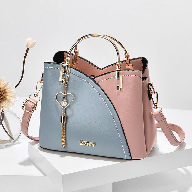Color block handbag with heart tassel